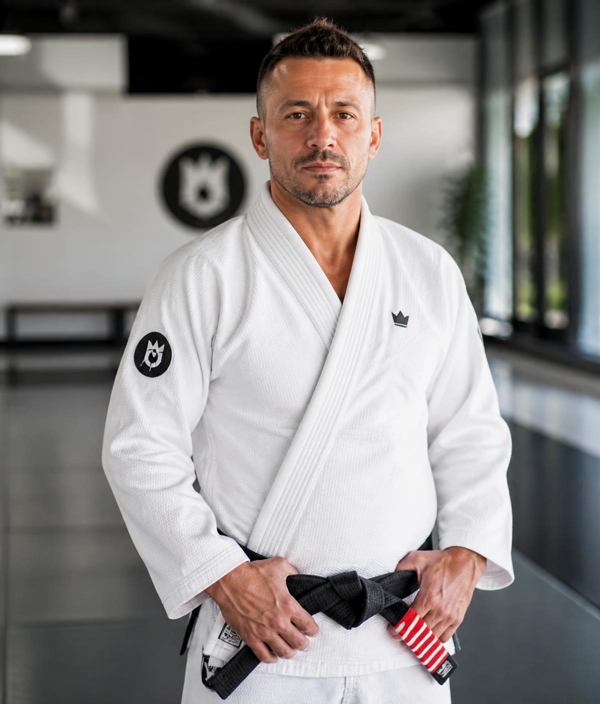 Head Coach Liam Stewart wearing a black belt in a white gi